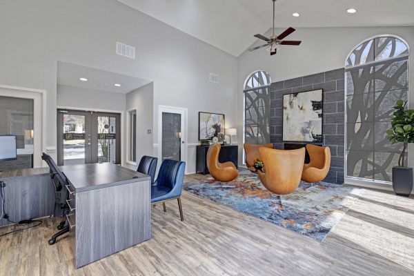 Village Green apartments community lounge with high ceilings and modern furnishings
