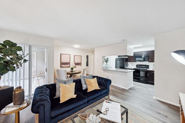 Altamonte apartments living room open floor plan with modern kitchen and plank flooring