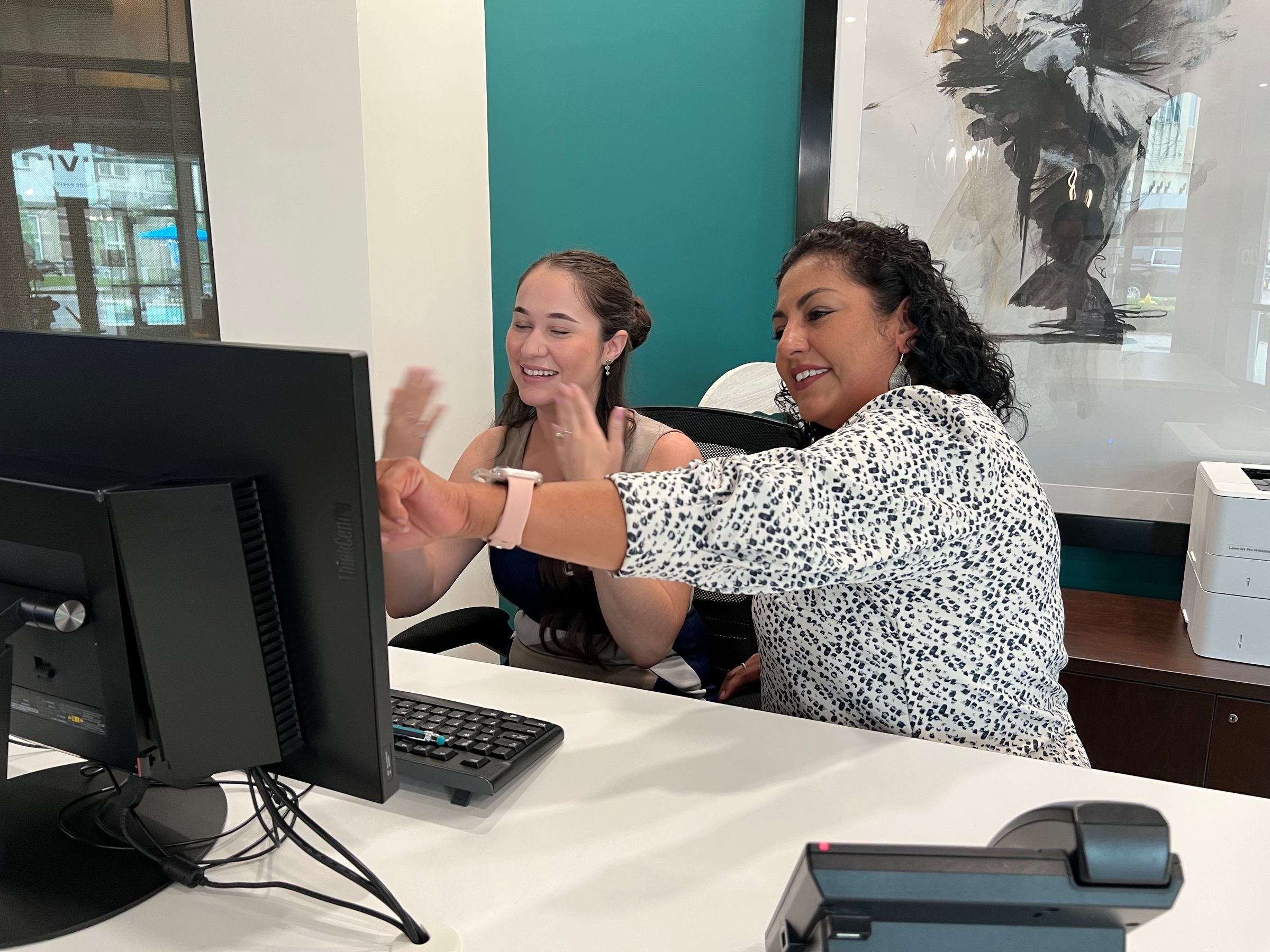 Two women looking at a computer screen