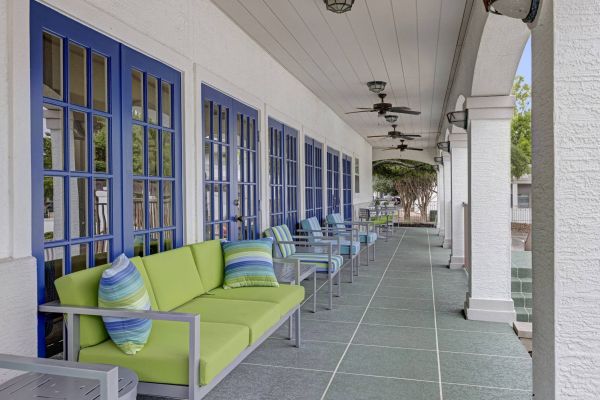 La Calera apartments outdoor lounge on extensive covered porch with comfortable couch seating