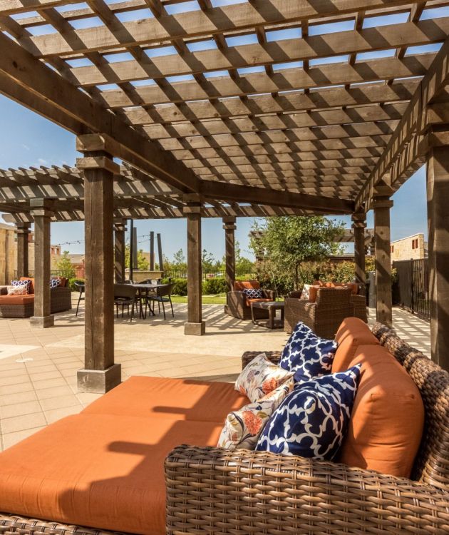 Gateway Cedars apartment exterior featuring large covered poolside patio and outdoor lounge