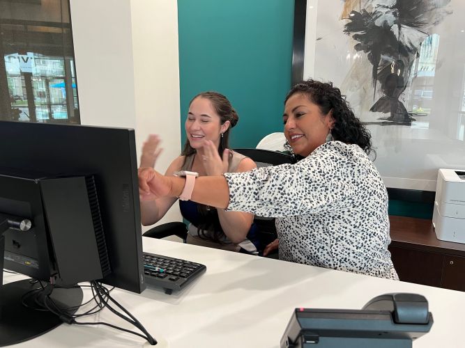 Two women looking at a computer screen