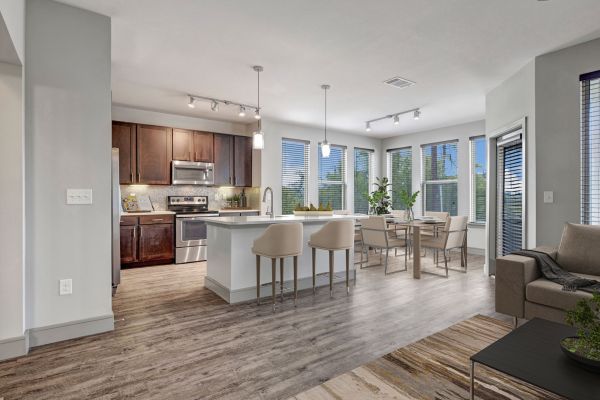 Enclave at the Dominion apartment interior featuring open floor plan and large wrap-around windows