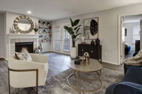 Crossings on Marsh apartment living room with large windows and plank flooring, alongside contemporary furnishings
