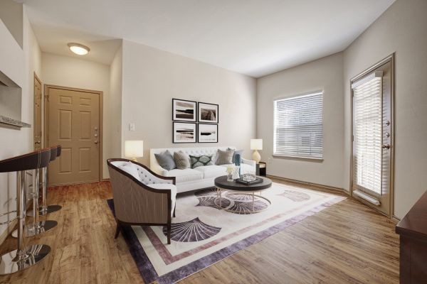 Elm Hollow apartments living room interior featuring large windows, plank flooring, and modern furnishings