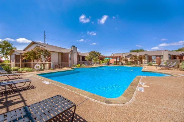 Valley Creek Apartments community pool and sundeck, with apartment buildings in background